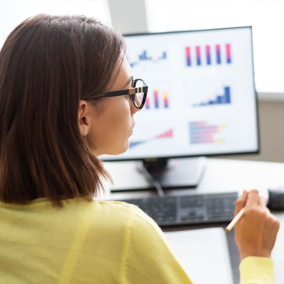 An analyst checking charts on a monitor
