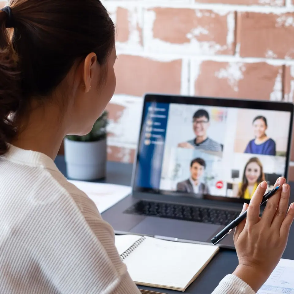A trainer leading a video session with a group